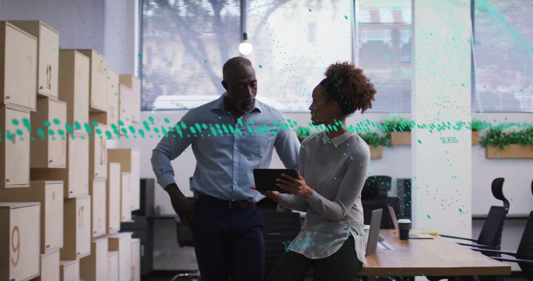 Diverse Coworkers Analyzing Data on Digital Tablet in Modern Office