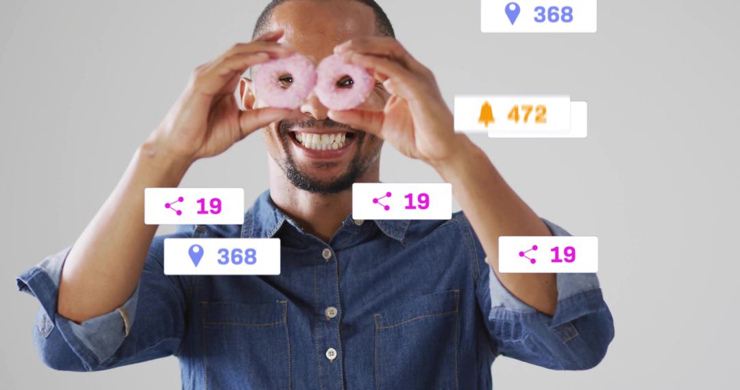 Playful Man Holding Donuts as Goggles with Floating Social Media Icons