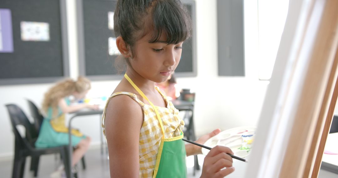 Young Girl Painting in Classroom Promoting Creativity and Learning
