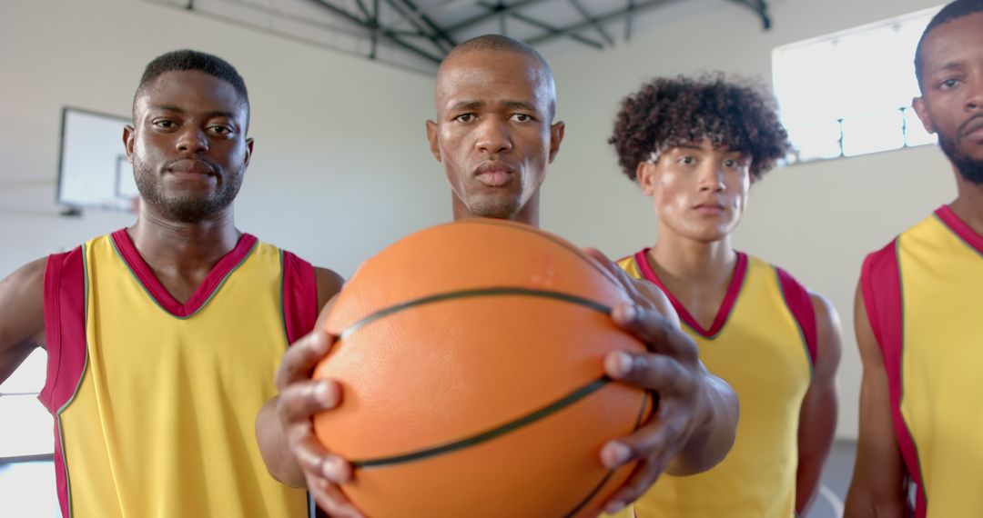Confident Basketball Team in Yellow Jerseys Displaying Teamwork and Determination