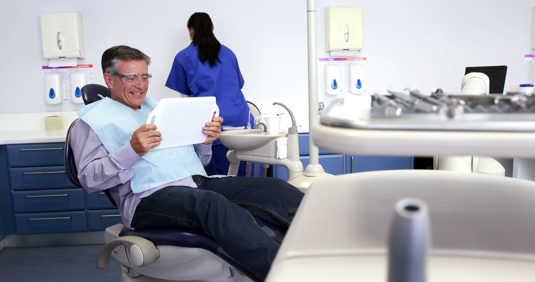 Patient Reviewing Dental Care Plan in Modern Clinic - Free Images, Stock Photos and Pictures on Pikwizard.com