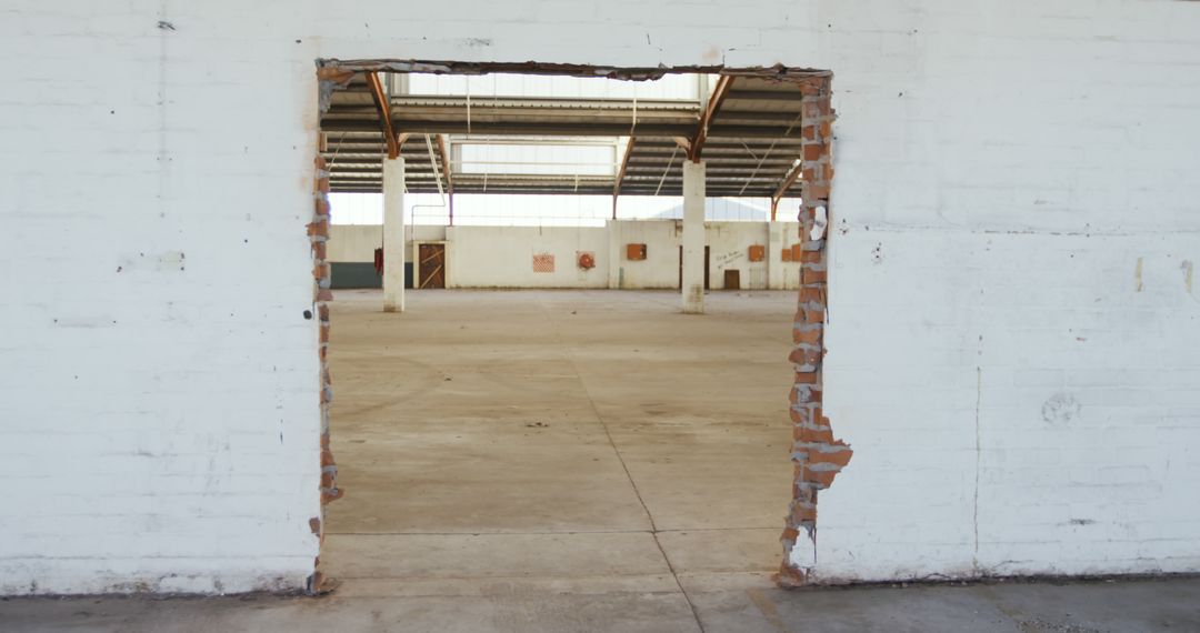 Partially demolished brick wall in empty warehouse - Free Images, Stock Photos and Pictures on Pikwizard.com