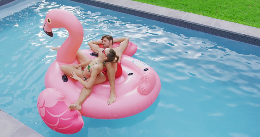 Couple Relaxing on Giant Flamingo Pool Float in Backyard Pool - Free Images, Stock Photos and Pictures on Pikwizard.com