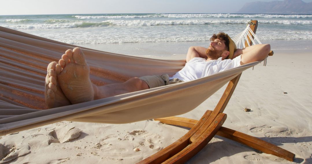 Man Relaxing in Hammock on Sandy Beach - Free Images, Stock Photos and Pictures on Pikwizard.com