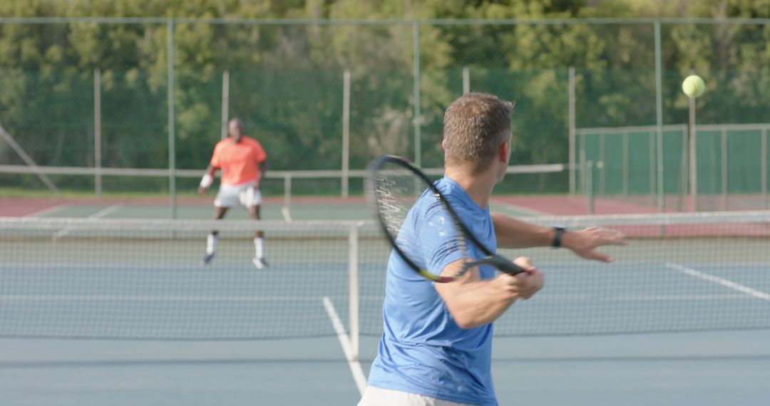 Two Men Playing Tennis on Outdoor Court, Active Recreation - Free Images, Stock Photos and Pictures on Pikwizard.com