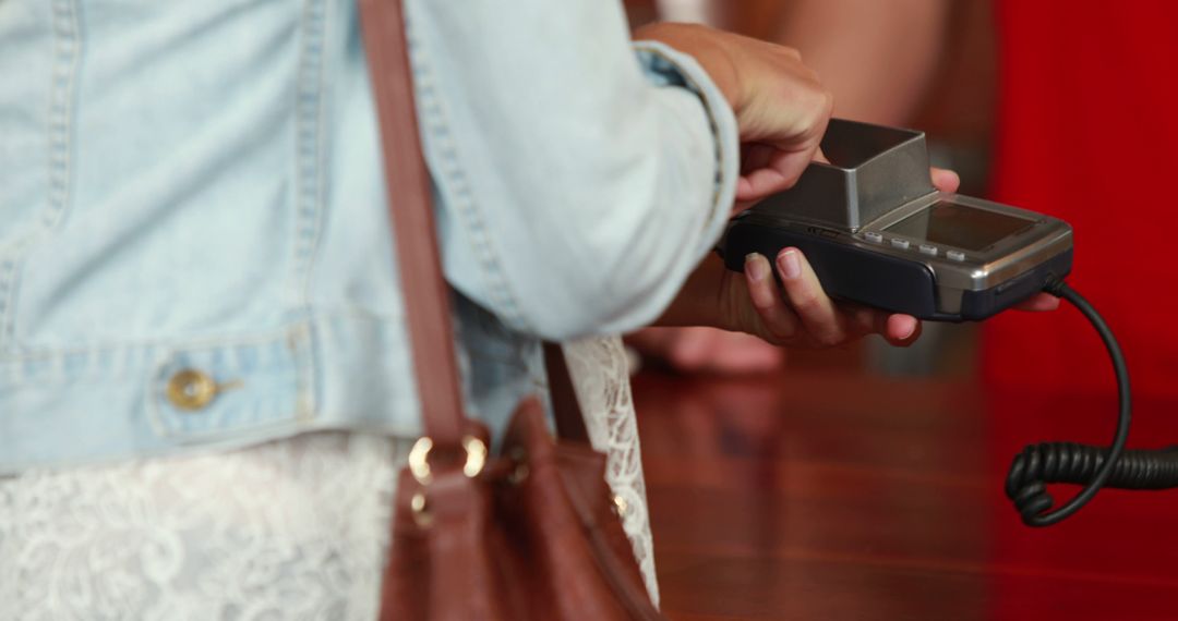 Customer making a wireless payment using a credit card terminal - Free Images, Stock Photos and Pictures on Pikwizard.com