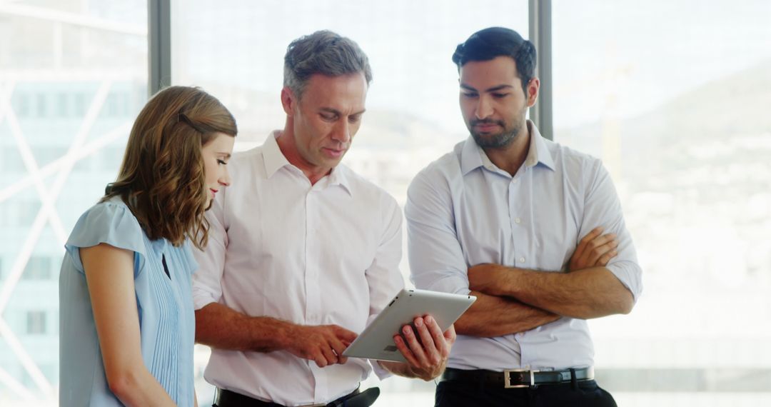 Diverse Professionals Collaborating Using Digital Tablet