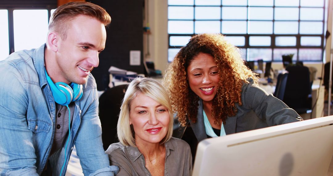 Team Collaborating on Computer in Modern Office Workspace