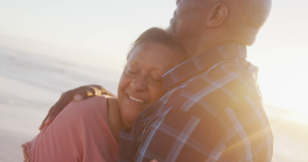 Joyful Senior African American Couple Embracing on Beach - Free Images, Stock Photos and Pictures on Pikwizard.com