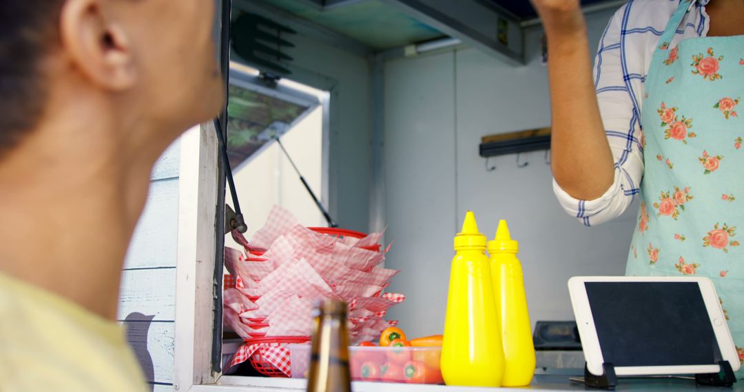 Customer Ordering at Food Truck with Condiments and Digital Tablet - Free Images, Stock Photos and Pictures on Pikwizard.com