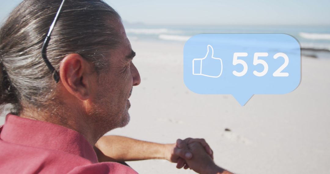 Senior Man Reflecting on Beach with Social Media Likes Bubble