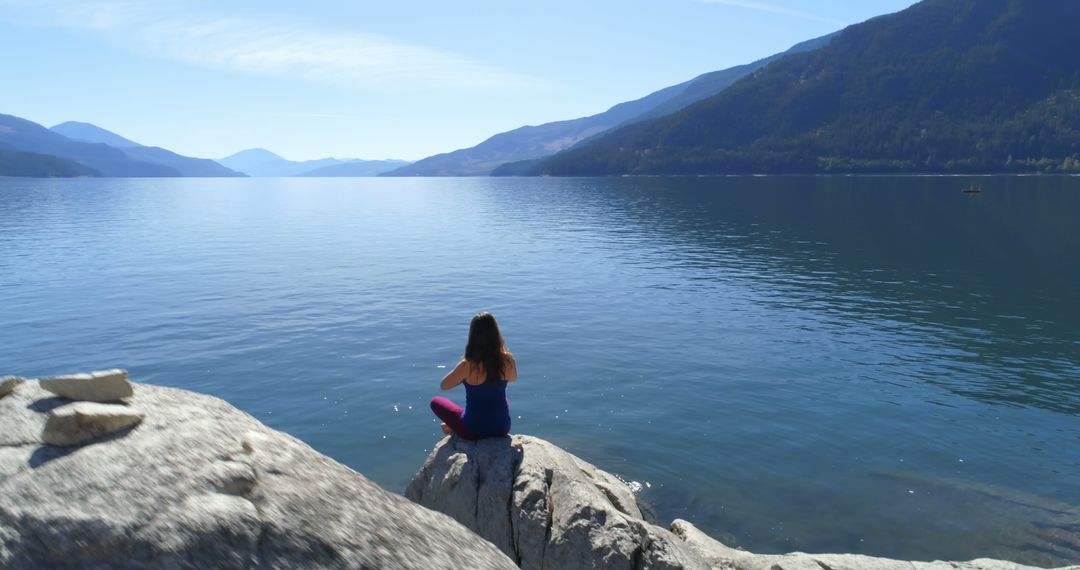 Woman Meditating at Scenic Mountain Lake - Free Images, Stock Photos and Pictures on Pikwizard.com