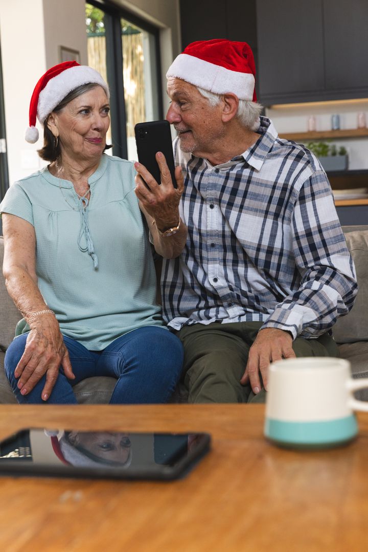 Senior Couple Enjoying Festive Video Call with Santa Hats