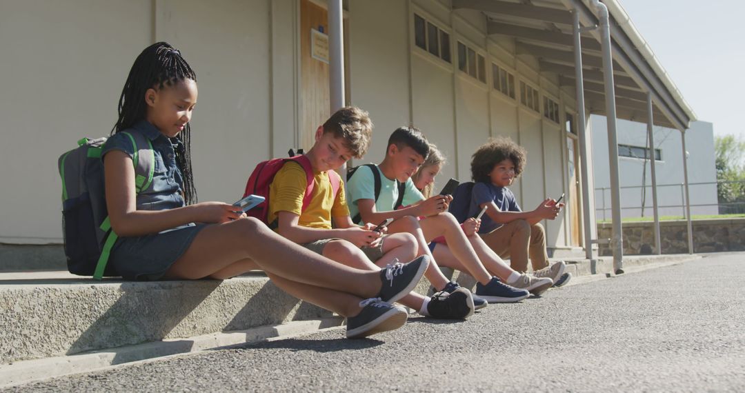 Diverse Kids at School Engaging with Smartphones Outdoors