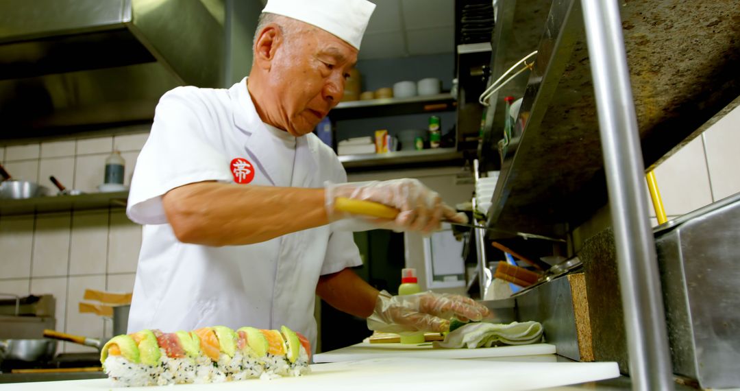 Experienced Sushi Chef Preparing Roll in Professional Kitchen - Free Images, Stock Photos and Pictures on Pikwizard.com