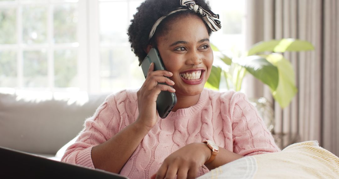 Smiling Woman Enjoys Relaxed Phone Call at Home