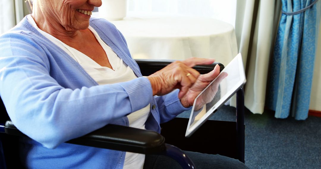 Senior Woman Using Digital Tablet in Wheelchair - Free Images, Stock Photos and Pictures on Pikwizard.com