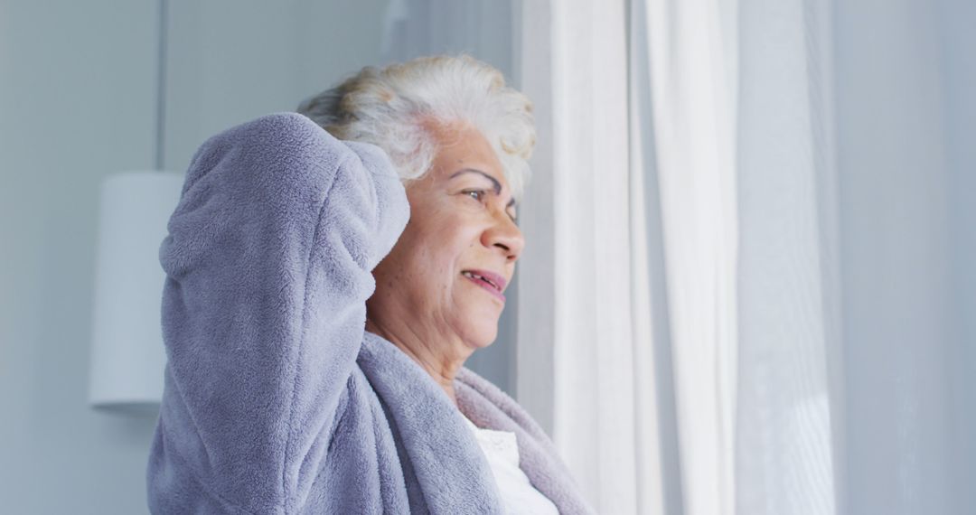 Elderly Woman Enjoying Morning Routine by Window - Free Images, Stock Photos and Pictures on Pikwizard.com