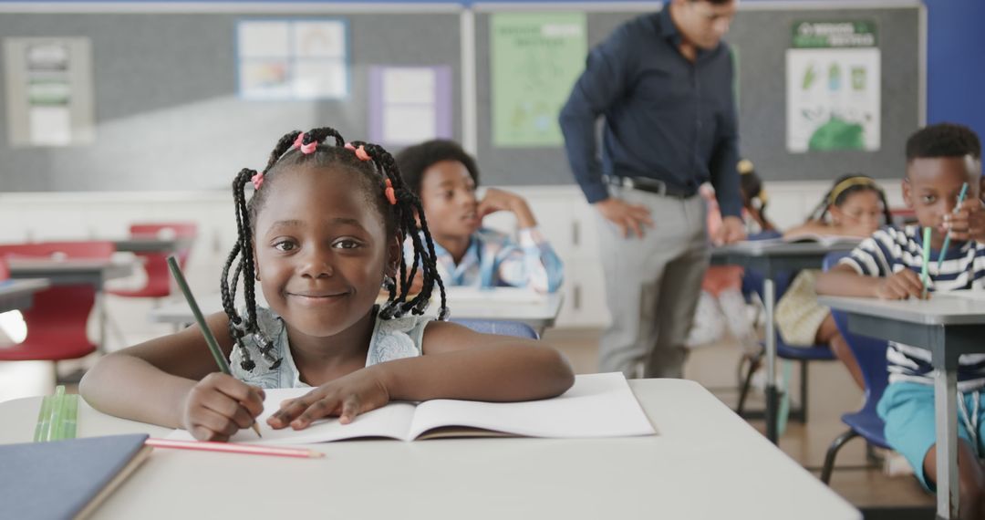 Excited African American Schoolgirl Writing in Classroom - Free Images, Stock Photos and Pictures on Pikwizard.com