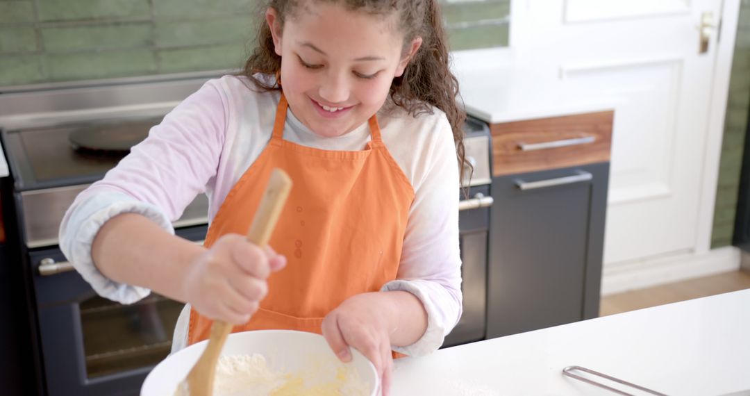 Young Girl Mixing Ingredients in Kitchen - Free Images, Stock Photos and Pictures on Pikwizard.com