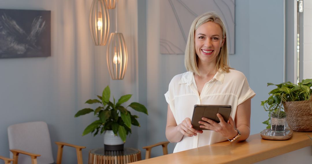 Receptionist Using Tablet in Modern Office Environment