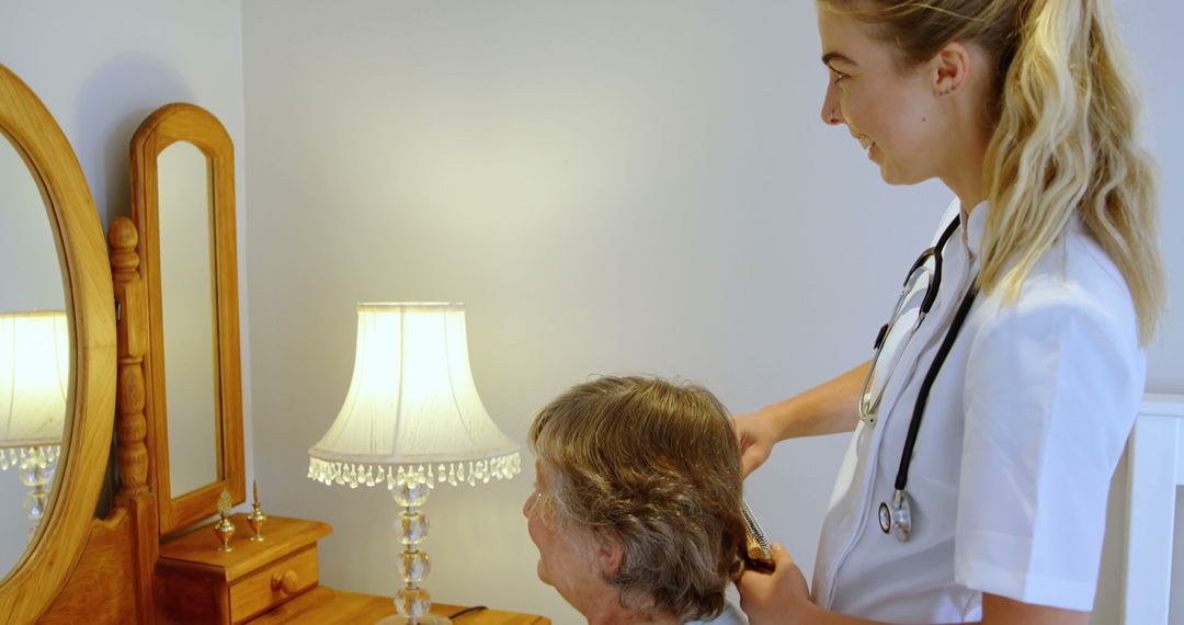 Caregiver Brushing Senior's Hair in Comfortable Home Environment - Free Images, Stock Photos and Pictures on Pikwizard.com