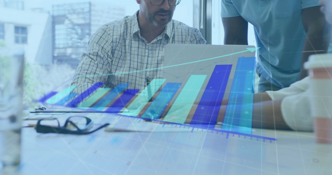 Team Analyzing Digital Charts in Modern Office Environment