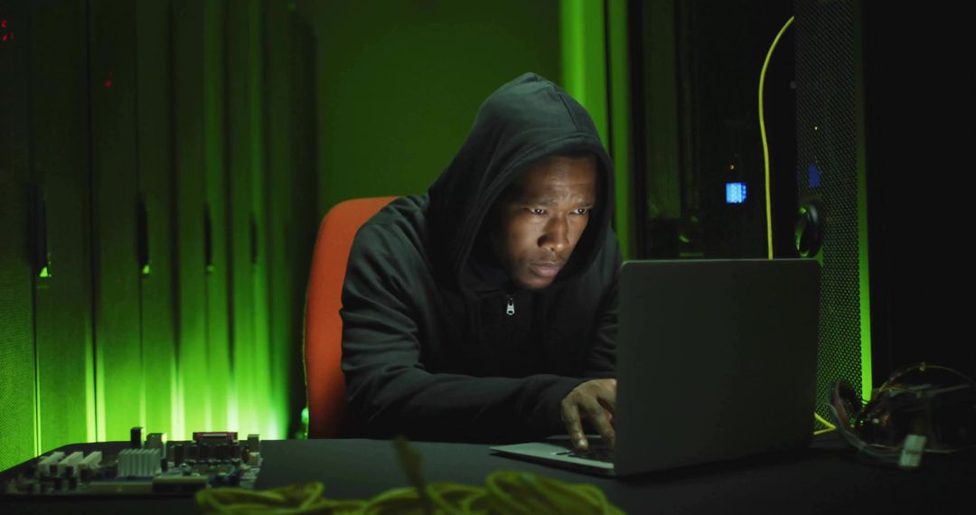 Engineer Repairing Circuit Board with Laptop in Dimly Lit Server Room