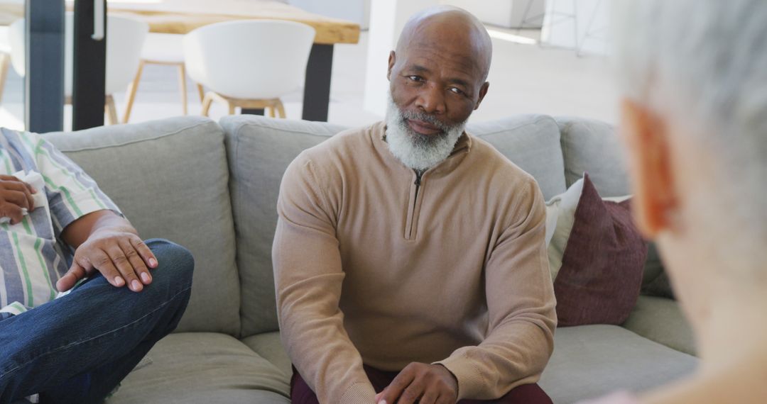 Older Man Engaging in Group Conversation on Cozy Sofa - Free Images, Stock Photos and Pictures on Pikwizard.com