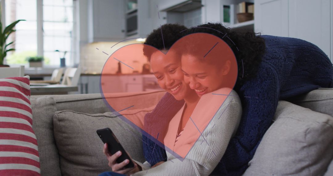 Two Women Enjoying Smartphone Time with Heart Graphic Overlay