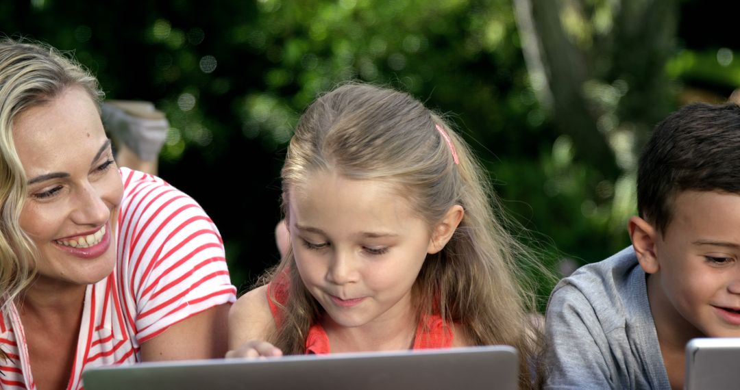 Mother Teaching Children on Tablets Outdoors - Free Images, Stock Photos and Pictures on Pikwizard.com