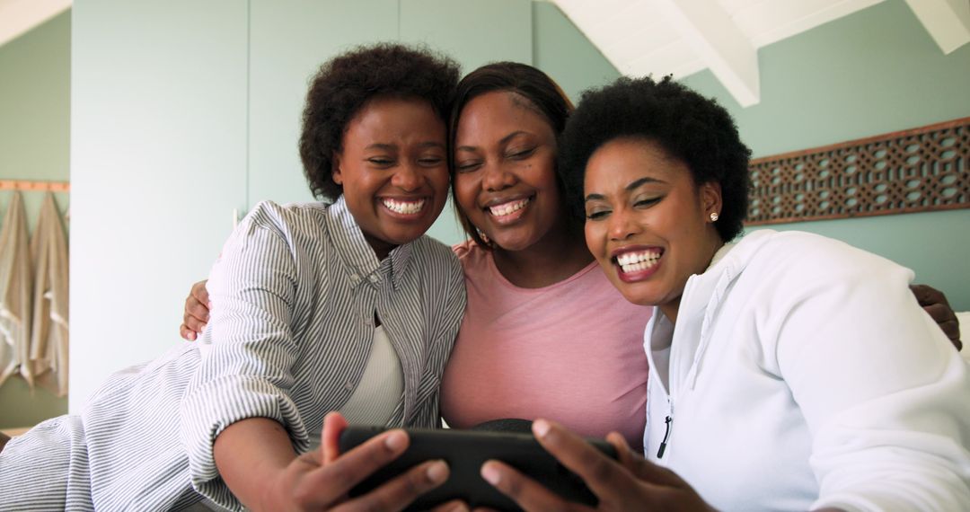 Three Friends Smiling at Device on Couch