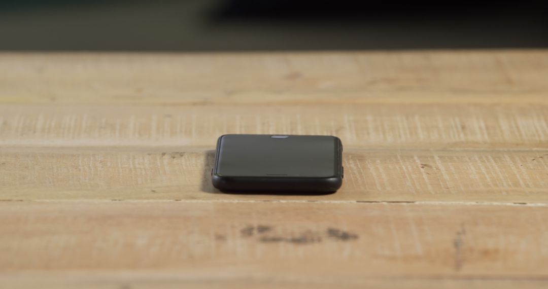 Stylish Black Smartwatch on Wooden Table Surface - Free Images, Stock Photos and Pictures on Pikwizard.com