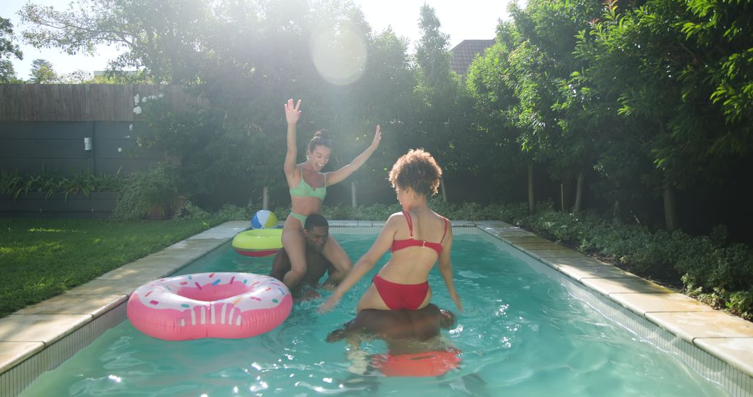 Diverse Friends Enjoying Refreshing Fun in Backyard Pool