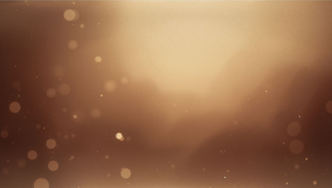Glowing sepia bokeh background spreading soft light with floating dust and warm orbs