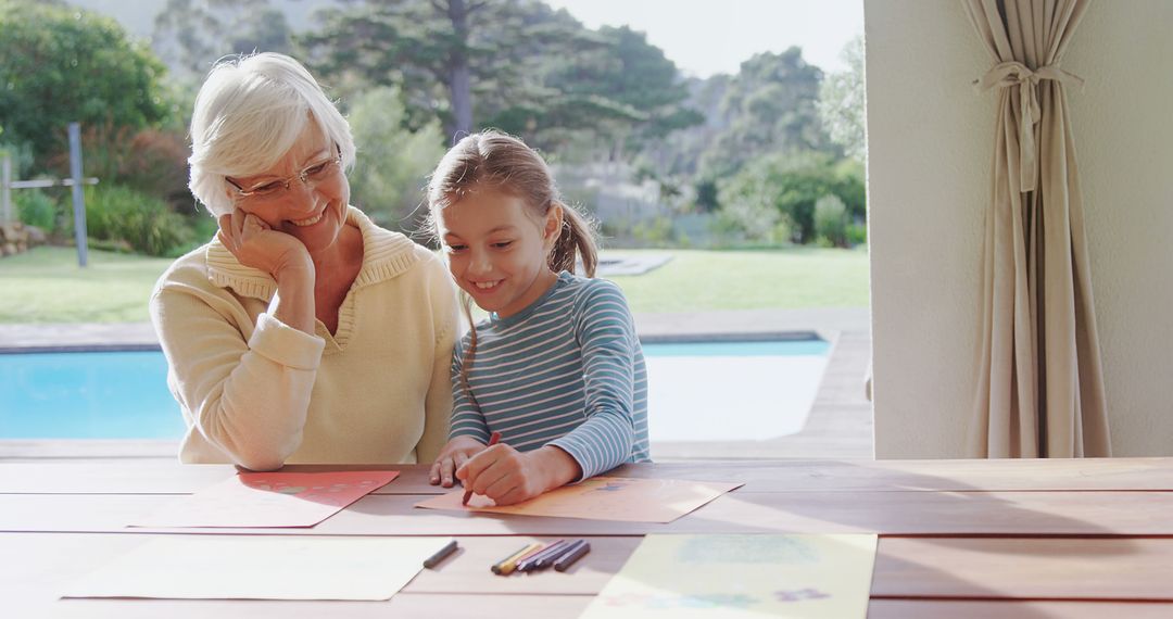 Senior Woman Enjoying Art Activities with Granddaughter by Pool - Free Images, Stock Photos and Pictures on Pikwizard.com