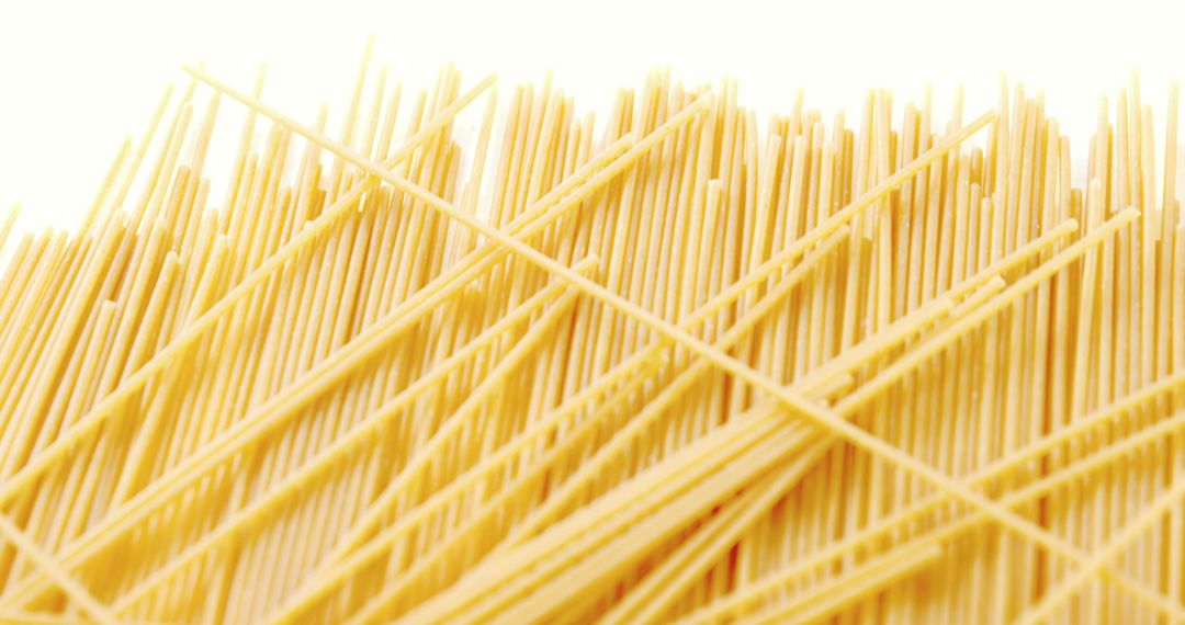 Close-up of raw spaghetti on white background - Free Images, Stock Photos and Pictures on Pikwizard.com