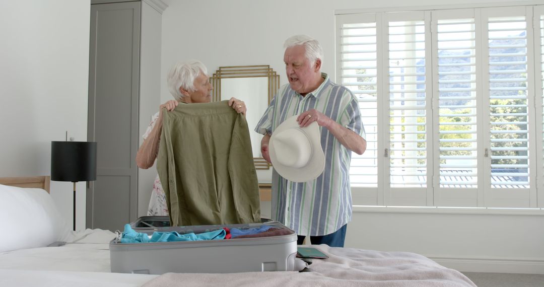 Senior Couple Packing Suitcase for Upcoming Vacation in Bright Bedroom - Free Images, Stock Photos and Pictures on Pikwizard.com