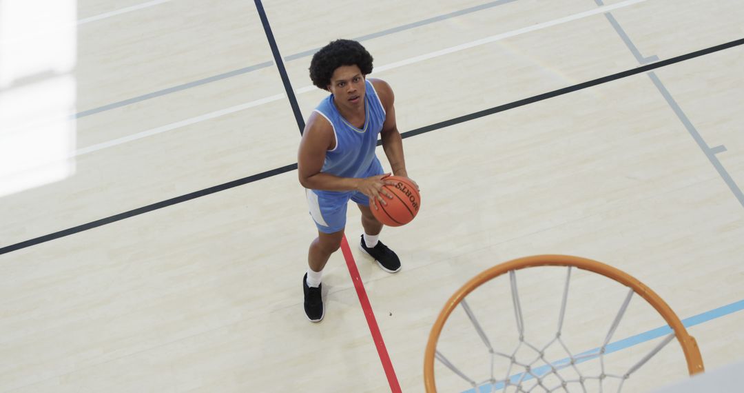 Basketball Player Taking Free Throw Shot on Indoor Court - Free Images, Stock Photos and Pictures on Pikwizard.com