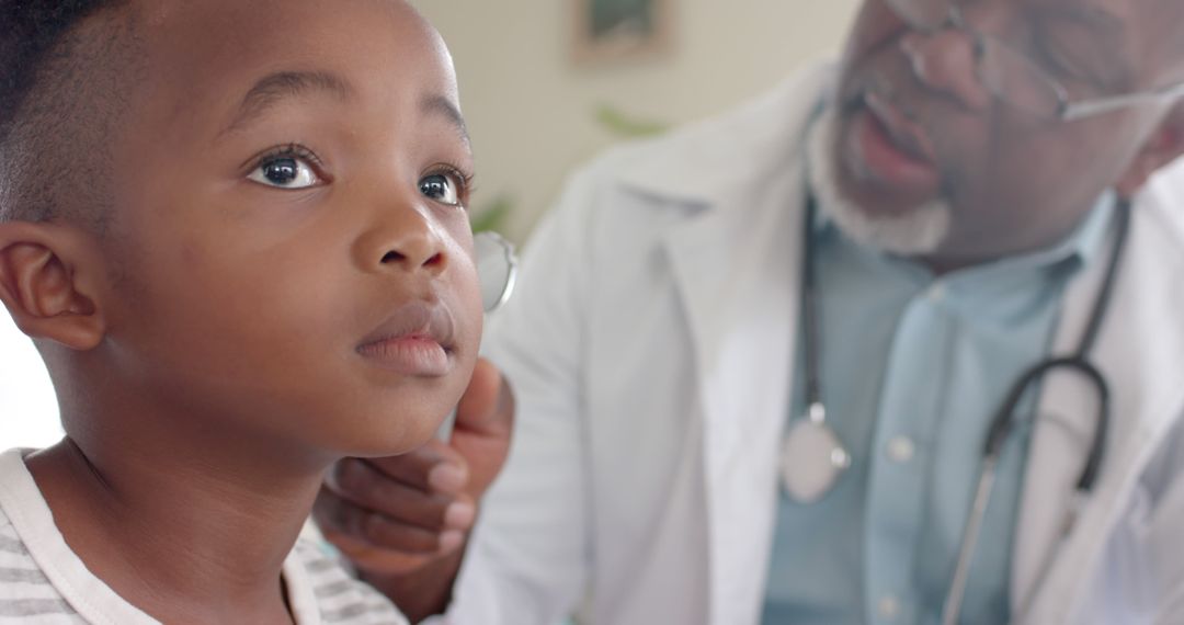 Pediatrician Examining Young Boy's Ear in Medical Office - Free Images, Stock Photos and Pictures on Pikwizard.com