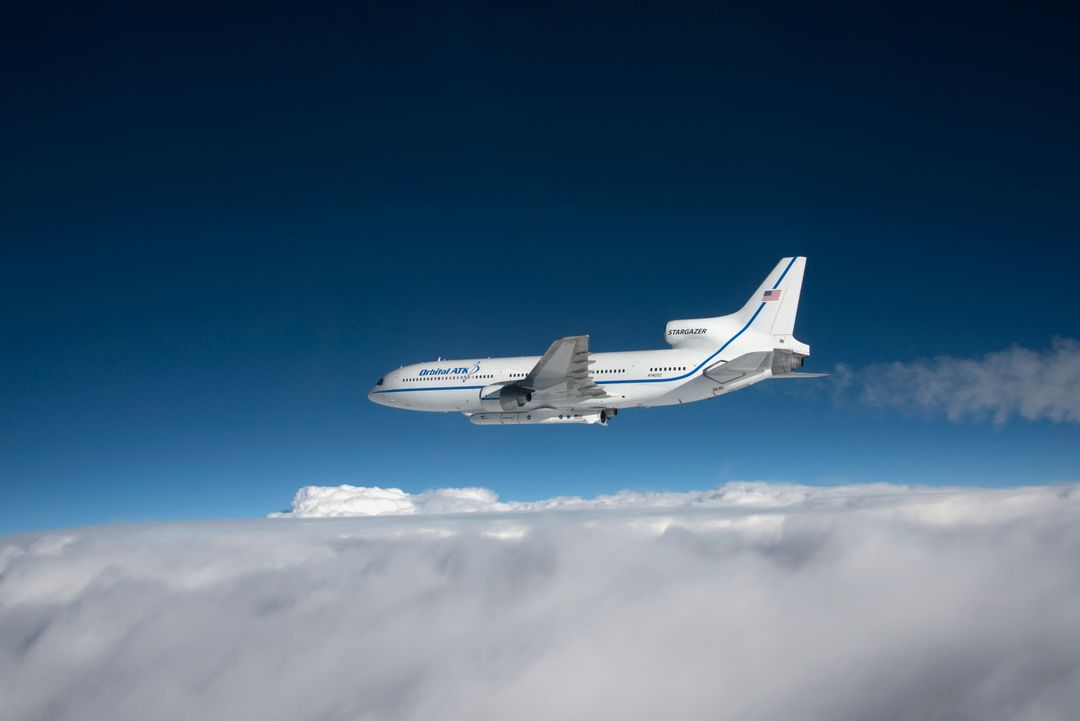 Orbital ATK L-1011 Stargazer Aircraft Flying Over Cloud Cover - Free Images, Stock Photos and Pictures on Pikwizard.com
