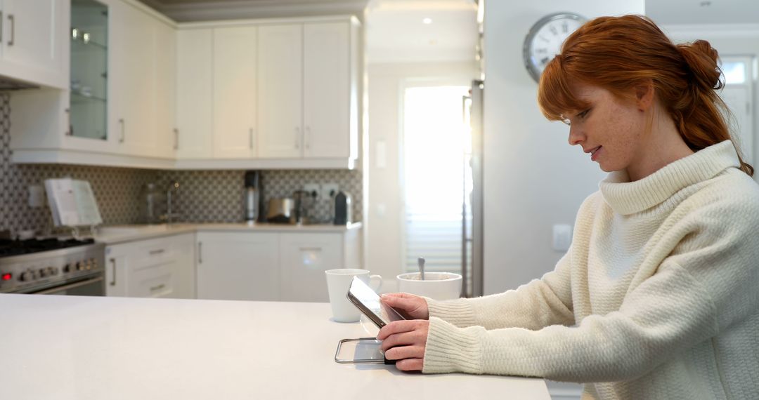 Red-haired Woman Using Tablet in Modern Kitchen - Free Images, Stock Photos and Pictures on Pikwizard.com