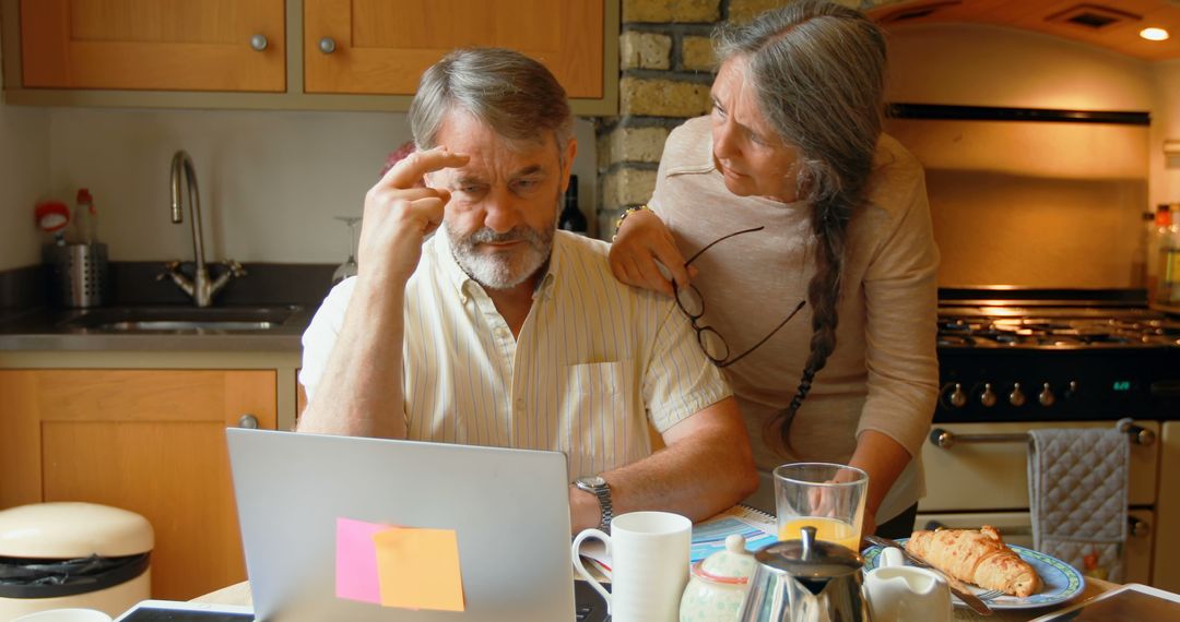 Senior Couple Using Laptop in Kitchen for Online Banking - Free Images, Stock Photos and Pictures on Pikwizard.com