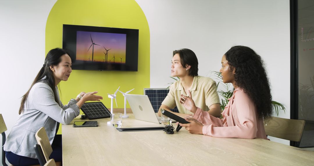 Diverse Team Discussing Renewable Energy in Modern Office