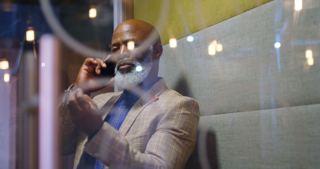 Confident Senior Businessman Talking on Smartphone in Modern Office - Free Images, Stock Photos and Pictures on Pikwizard.com