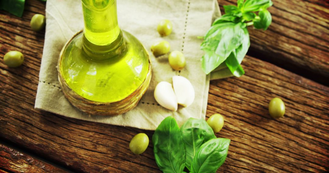 Fresh Olive Oil with Basil, Garlic and Olives on Wooden Table - Free Images, Stock Photos and Pictures on Pikwizard.com