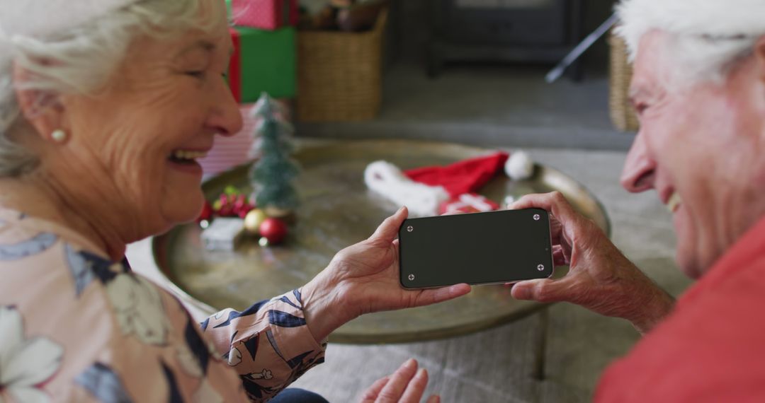 Senior Couple Video Calling on Smartphone During Christmas Celebration - Free Images, Stock Photos and Pictures on Pikwizard.com