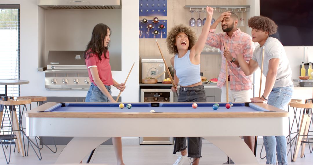 Diverse Group of Friends Celebrating and Playing Pool Inside Modern Home
