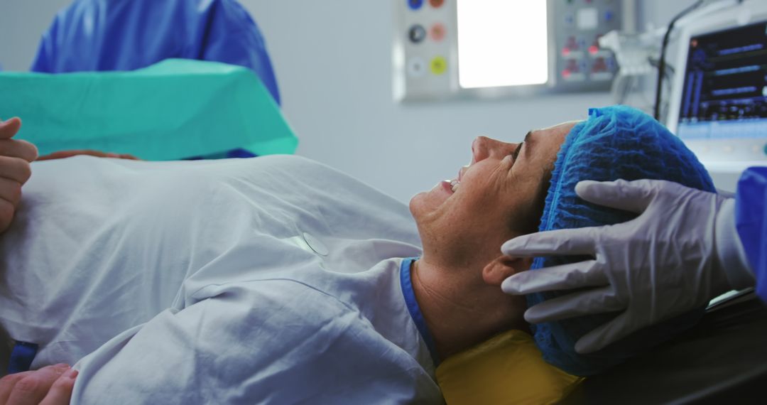 Man comforting pregnant woman during labor in operation theater at hospital - Free Images, Stock Photos and Pictures on Pikwizard.com