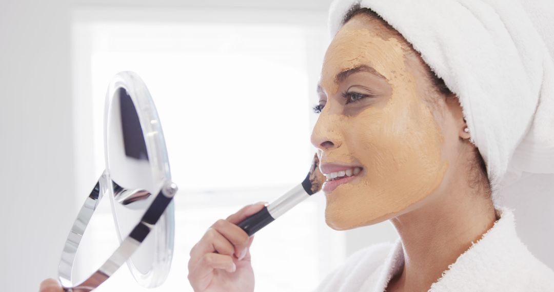 Woman Applying Clay Face Mask with Brush in Spa Setting - Free Images, Stock Photos and Pictures on Pikwizard.com